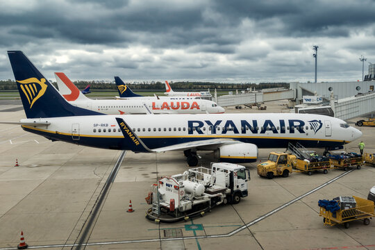 Ryanair Boeing 737 and Lauda aircrafts at Vienna International Airport under an overcast sky..