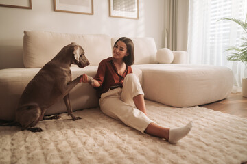 An Affectionate Moment Shared Between a Woman and Her Dog in a Cozy Living Room
