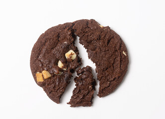 Pieces of one large chocolate chip cookie on white background. Isolated. Flat lay