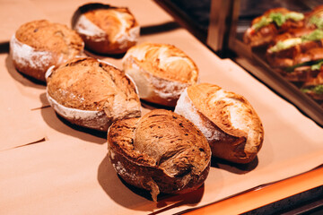 Freshly baked bread on supermarket shelf, bakery display.