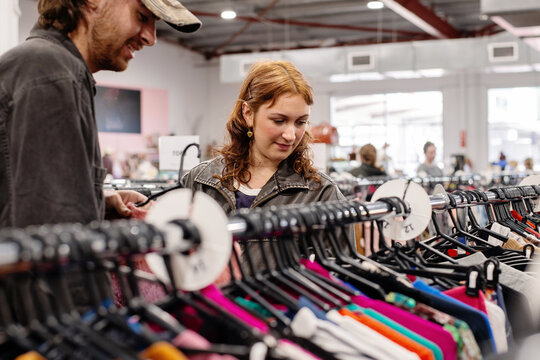 a genZ couple shopping in a thrift store