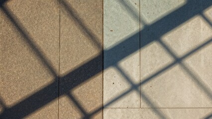 Division of ground into light and shadow zones highlighting a building's outline in an abstract theme.