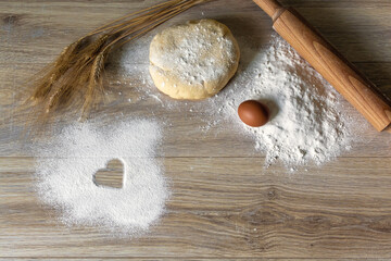 Homemade Baking Ingredients with Heart Symbol in Flour