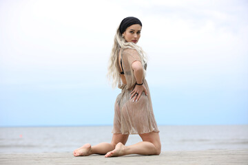 Woman Posing Gracefully on a Beach Boardwalk