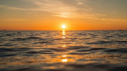Obraz premium Sunset's golden rays shimmering across the water