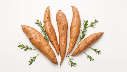 Sweet potatoes arranged on a table against a white backdrop
