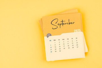 September 2025 calendar card on yellow color background with copy space.