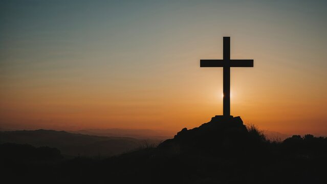 Easter theme with a darkened cross atop a mountain against a sunset sky