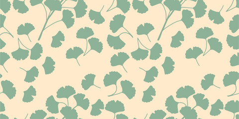 Botanical seamless pattern of silhouettes of branches and leaves of ginkgo biloba in green on light background. For prints of fabrics, textiles, packaging.