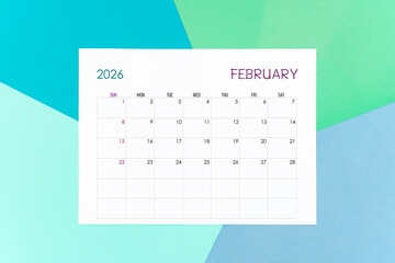 February calendar card for 2026 year on colorful background. Flat lay.