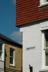 Classic British street sign mounted on a white wall in Cornwall, England, reflecting the charm and...