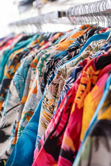 Colorful tropical shirts on clothing rack