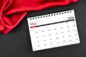 May 2026 Monthly desk calendar with red silk on black color leather background.