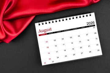 August 2026 Monthly desk calendar with red silk on black color leather background.