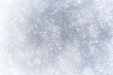 Close-up shot of layered snowflakes, creating a dreamy, soft-focus texture. Aesthetic winter backdrop with copy space 