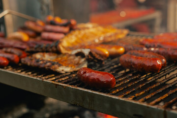 Grilled meat and sausages being served at a lively street festival during the Santos Populares celebration in Lisbon, Portugal. The traditional Portuguese food. Close up, soft focus. Part of a series