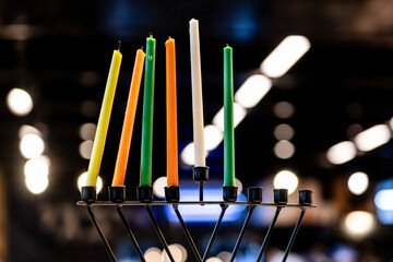 Multi-colored, unlit, wax Hanukkah candles ready for lighting on a Chanukah menorah.