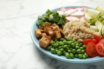 Different healthy vegetarian food on white marble table, closeup. Space for text