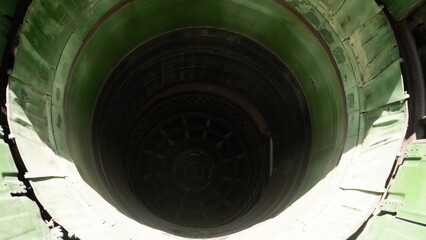 Significant circular opening reveals a vintage green interior, likely part of an industrial site in the USSR, highlighting engineering feats from the Soviet era.