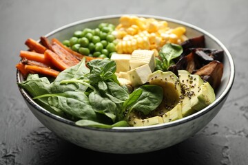 Healthy vegetarian food. Delicious Buddha bowl on black table, closeup