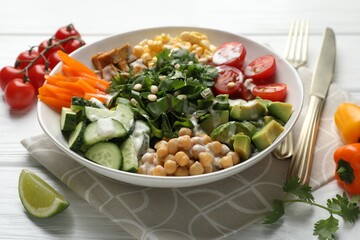Different healthy vegetarian food served on white wooden table, closeup