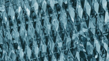 Close-up of a modern commercial building portion. Abstract geometric design. Facade segment of a tall building with glass windows.