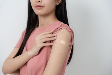 woman show after getting a vaccination. receive a dose of immunization virus vaccine from a nurse or doctor at the medical center, basic vaccine, alternative vaccine, vaccine for risk group