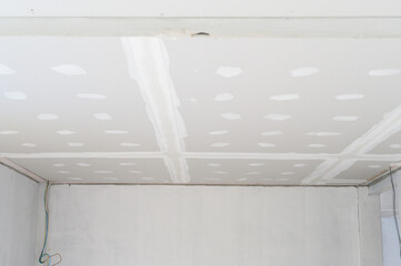 Observing process of building interior renovation gypsum board ceiling installation shows smooth...