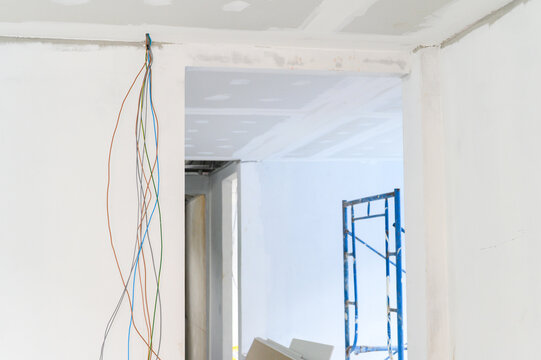 Interior renovation reveals gypsum board ceiling and wall smooth edges showing electrical wire progress se smooth plastering prepares ceilings throughout building project for future home