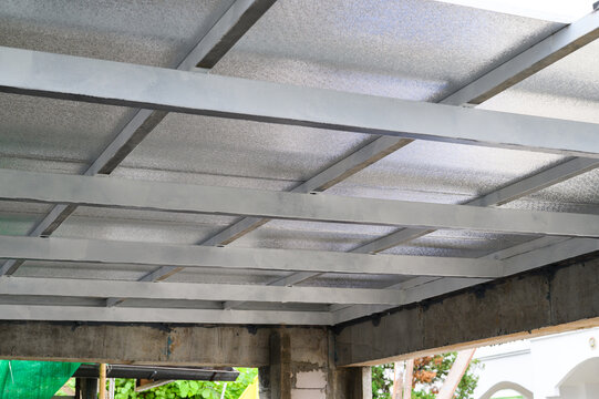 View of robust building structure during construction featuring concrete beams and metal framework. Sandwiched sheet panels likely contain pu foam insulation providing thermal properties