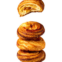 Fototapeta premium Stack of pastries falling in mid air against black background