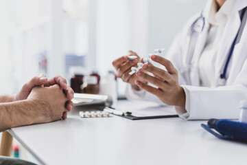Female doctor explaining medicine dosage to patient during appointment in medical clinic. Health...