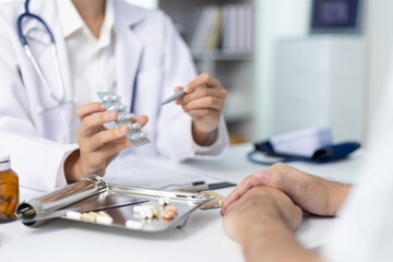 Female doctor explaining medicine dosage to patient during appointment in medical clinic. Health...
