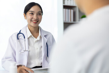 Friendly female doctor discussing diagnosis with patient during medical consultation in clinic...