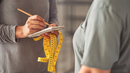 Measuring a woman's body with a tape measure