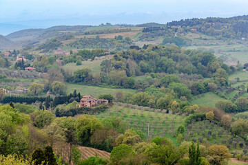 Views of rolling hills and a rustic villas in Tuscany