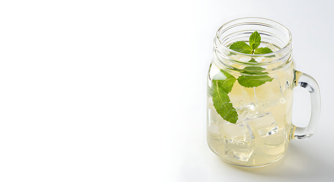A mason jar filled with cold lemonade, ice cubes, and mint leaves, isolated on a pure white background with bright lighting