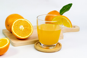 Fresh Orange Juice and Whole Oranges on White Background