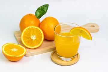 Fresh Oranges and Bright Orange Juice on a Wooden Board