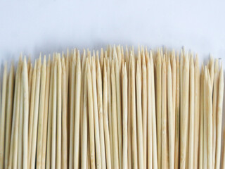 isolated on white background close up of wooden skewer with pointed tip.Disposable bamboo thin long skewer.