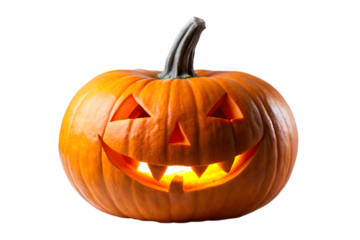 A carved halloween pumpkin with a glowing light inside and a spooky face is isolated on a transparent background
