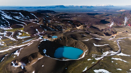 Marvel at the breathtaking beauty of Krafla Crater, featuring vibrant turquoise waters surrounded...