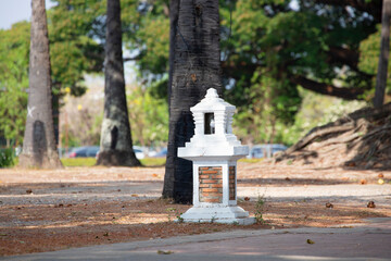 Ancient garden lamps made of cement and red brick painted white.