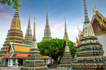 Fototapeta premium Buddhist pagodas of Wat Phra Chetuphon - Wat Pho temple in Bangkok, Thailand, decorated with colorful tiles