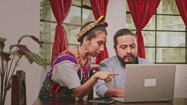 A married couple shopping online. The couple uses online services to conduct electronic transactions.