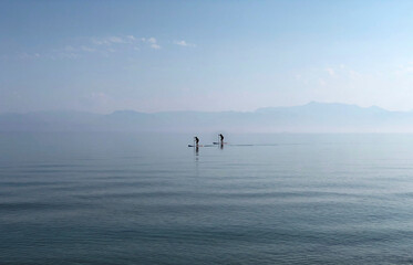 Two Men Paddle In Ionian Sea Near Sidari On Corfu Island