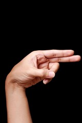 Close-up of a hand gesture resembling a gun sign.