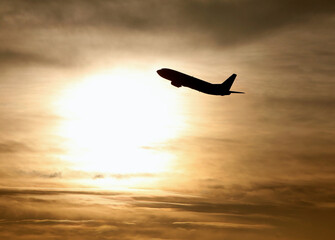 Silhouette-of-Airplane-Flying-During-Sunset-or-Sunrise