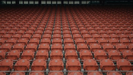 Empty orange seats in a sports venue amid pandemic restrictions