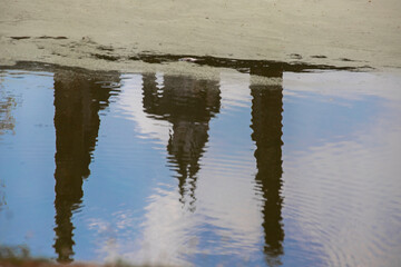 The reflection of a pagoda and buddha image in the lotus pond.